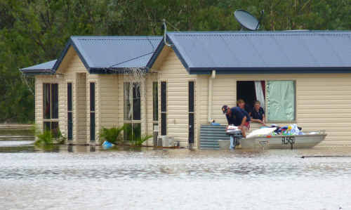 Damian Upton, Jodie Griffiths and Darlene Johnson load a boat with contents from the Upton house as the water rises. Damian Upton, Jodie Griffiths and Darlene Johnson load a boat with contents from the Upton house as the water rises.
